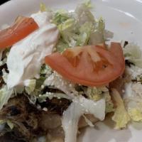 One Sope · deep fried corn dough (round shape) topped with beans, lettuce, sour cream, cotija cheese, p...