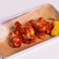 Hot Wings  · Deep fried chicken wings tossed in our hot sauce and served with choice of ranch or spicy ra...