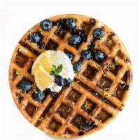 Blueberry Waffle · A golden brown waffle baked with delicious blueberries. Served with fresh whipped cream.