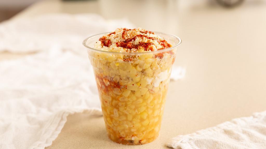 Elote En Vaso · Corn in a cup with sour cream, mayo, cotija cheese, Valentina and tajin.