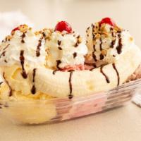 Banana Split · 3 big ice cream scoops, flavor of your choice, with a banana topped with whipped cream, choc...