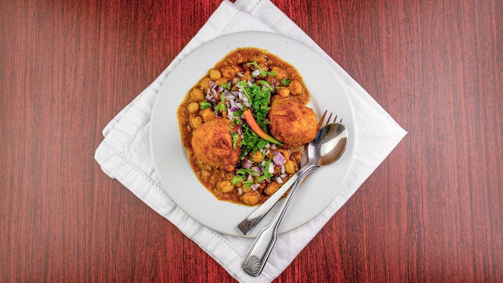 Samosa Chana · A fried pastry with savory fillings, spiced potatoes, peas, onions and ginger topped with chickpeas.