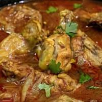 Chicken Curry · Boneless chicken stewed in onion and tomato sauce with ginger, garlic and chilies.