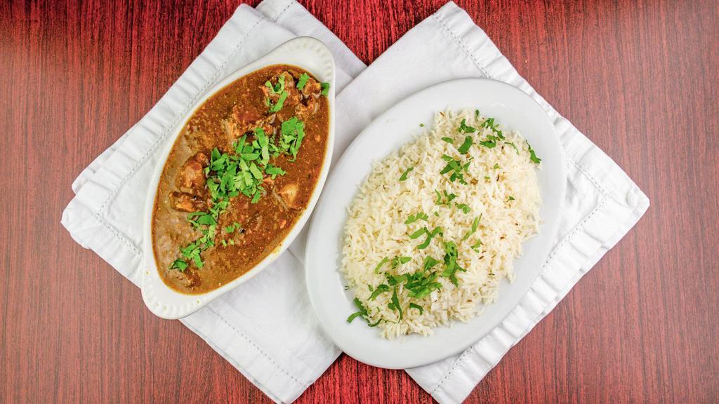 Goat Curry · Small piece of goat in curry sauce with special spices and basmati rice.