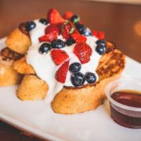 French Toast · Baguette, Greek yogurt, berries, pure agave syrup.