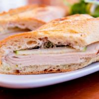 Turkey · Baguette, roasted natural turkey, walnut spread, green apple, scallion aioli.