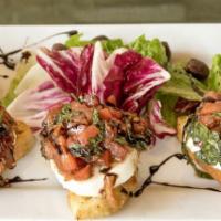Fresh Mozzarella Bruschetta · Toasted sliced bread topped with tomatoes, garlic, basil and fresh mozzarella in our homemad...