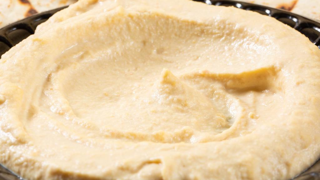 Hummus · A perfect blend of chickpeas, tahini, lemon juice, and spices served with olive oil.