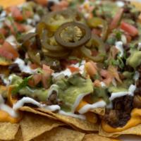 Super Nachos · Fresh chips topped with your choice of meat and melted american cheese, sour cream, guacamol...