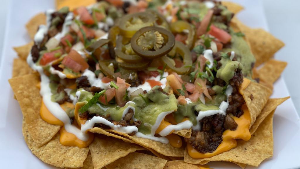 Super Nachos · Fresh chips topped with your choice of meat and melted american cheese, sour cream, guacamole, pico de gallo and jalapenos.