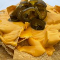 Reg Nachos · Fresh Chips with melted american cheese and jalapenos.