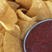 Chips And Salsa · One plate of house corn chips with 4oz red salsa.