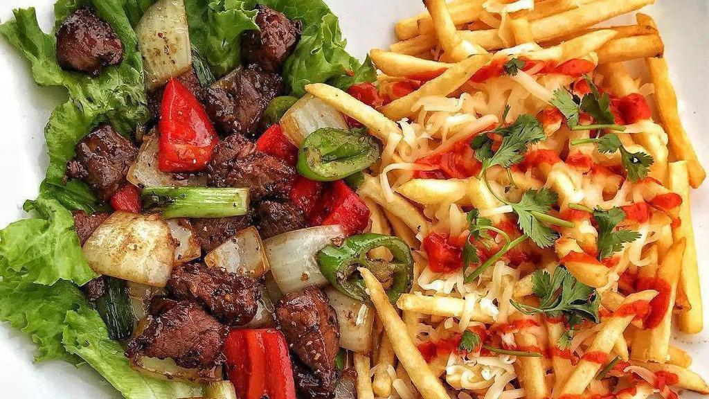 Shaken Beef And Fries · French fries with shaken beef.
