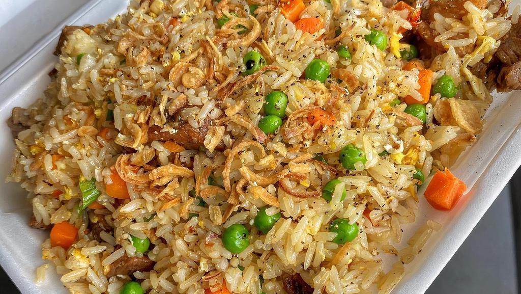 Chicken Fried Rice · Fried rice stir-fried with egg, marinated chicken with pea and carrots, and green onions.