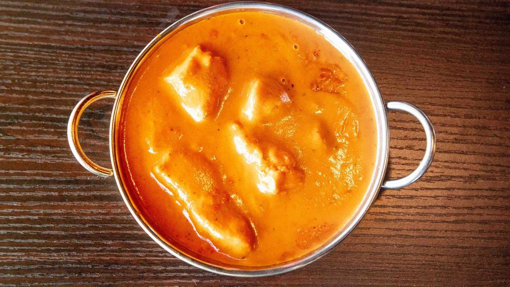 Chicken Tikka Masala · Clay oven roasted boneless chicken breast cubes cooked in a creamy sauce with herbs and spices.