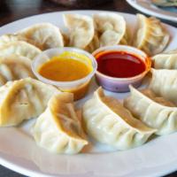 Chicken Momo (10 Pieces) · Steamed dumplings filled with minced chicken, onion, cilantro and spices. Served with specia...