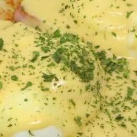 Eggs Benedict · Toasted English muffin topped with ham, poached eggs, and hollandaise sauce served with choi...