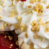 Banana Split · Vanilla ice cream topped with chocolate, caramel, strawberry syrup, whipped cream, and nuts.