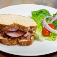 The Tower District · Lettuce tomato red onion bacon sliced ham and turkey on wheat bread.