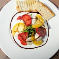 Insalata Caprese (Vegetarian) · This dish contains sliced mozzarella fiordilatte,  large heirloom tomatoes, and arugula whic...