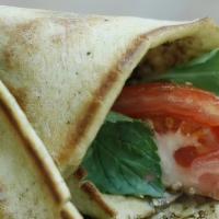 Extra Zaatar Manakeesh  · Flatbread with thyme and olive oil with mint, tomatoes and cucumber.