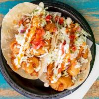 Grilled Baja Taco · Fish and shrimp on a flour tortilla topped with cabbage, pico de gallo, salsa and cream. (gr...