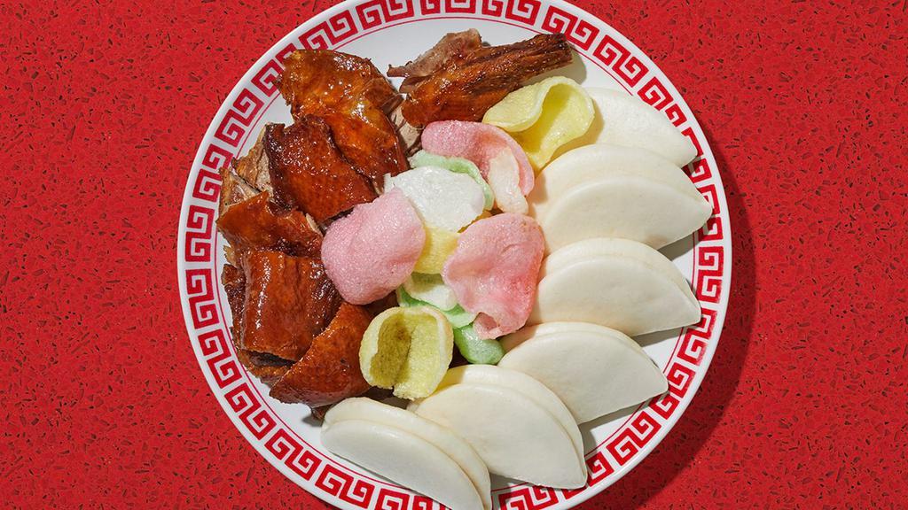 Peking Duck · Crispy fried duck with a sweet and tangy sauce.