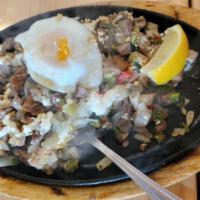 Pork Sisig · Chopped lechon kawali, grilled pork liver and pork ears mixed with onios, scallions, jalapen...