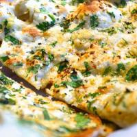 Garlic Basil Naan · Leavened white flour bread baked in a clay oven with garlic and basil,.