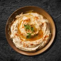 Classic Chickpea Hummus · Chickpeas boiled till soft, mashed, blended, and mixed with garlic, tahini sauce, olive oil,...