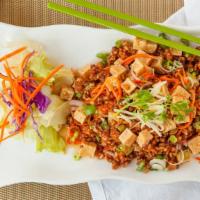 Crispy Rice Salad · Crispy brown rice mixed with fried tofu, ginger, onion, carrot and peanut with spicy lime dr...