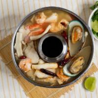 Seafood Tom Yum · Made with shrimp, fish, mussels, squid, and imitation crab meat in a sour and spicy broth.