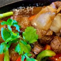 (Sp3) Bo Luc Lac / Vietnamese Shaken Beef · Sizzling beef served over a bed of fresh lettuce, cucumbers, tomatoes, and onions