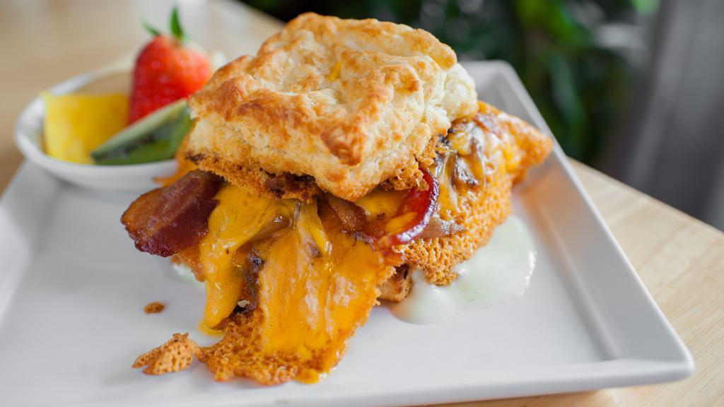 Biscuit Sandwich · bacon.  caramelized onion.  cheddar cheese skirt. chive mascarpone.  egg.  griddled biscuit.  fruit or potatoes.