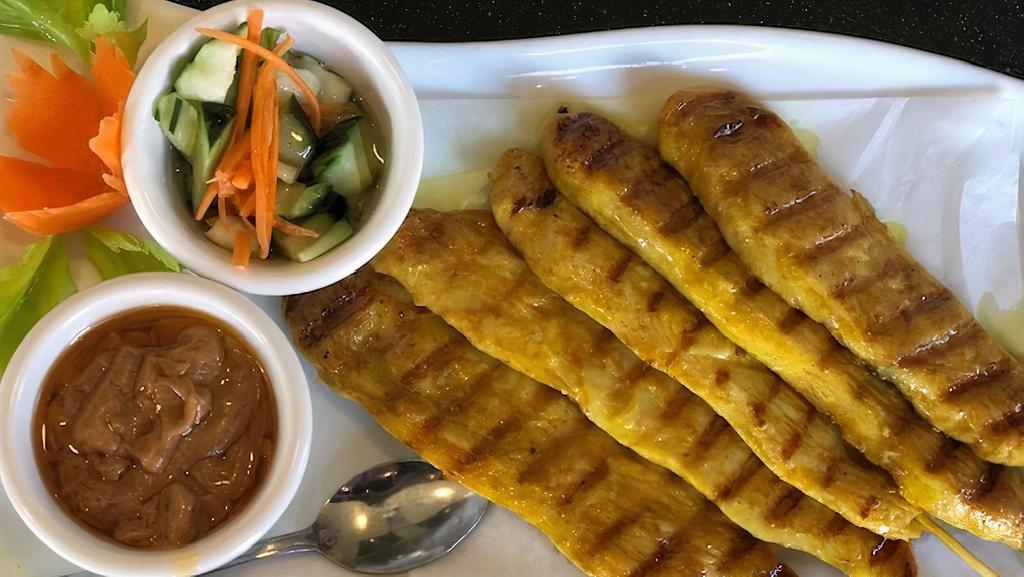 Chicken Satay (5 Skewers) · Chicken marinated with herbs, grilled on a skewer served with peanut sauce and cucumber sauce.