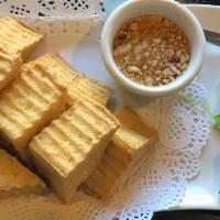 Fried Tofu (8 Pcs) · Deep-fried tofu serve with sweet and sour sauce on top of crunch peanut.