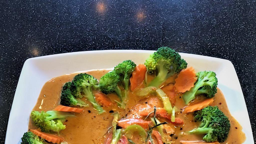 Panang Salmon · Grilled Salmon, panang curry sauce, bell peppers, coconut milk on top with kafir lime leaves