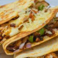 Chicken Quesadilla · LArge grilled flour tortilla filled with Mozzarella cheese, Cheddar cheese, and grilled chic...