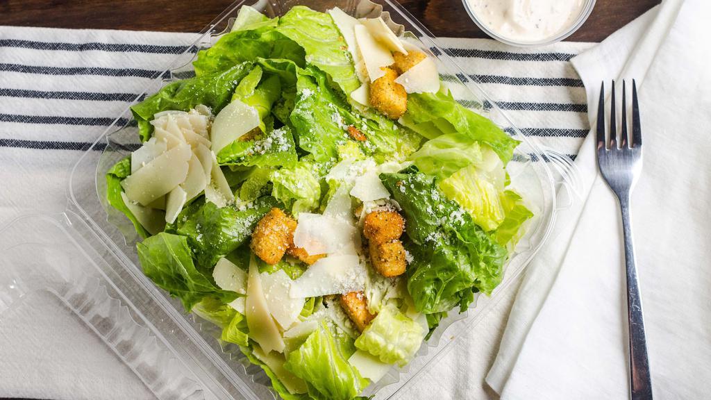 Caesar Salad · Crisp romaine leaves tossed with Parmesan cheese. Topped with garlic-herb croutons.