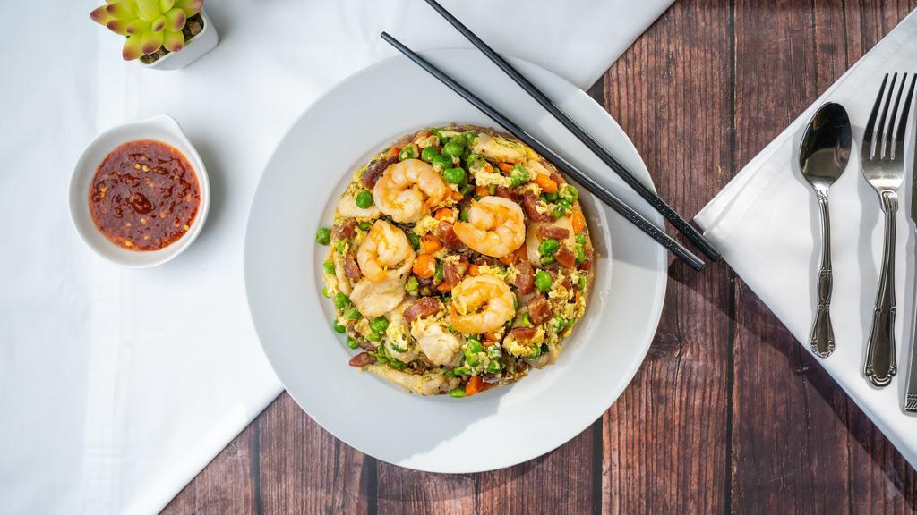 Volcano Fried Rice · Our best seller! Shrimp, chicken, and Chinese sausage scrambled with eggs, peas, & carrots over fried rice.