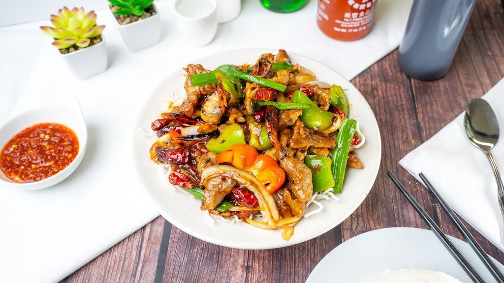 Mongolian Beef Or Chicken · Spicy beef or chicken stir-fried with onions and chili peppers over crispy rice noodles