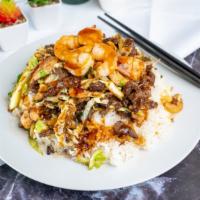 Teriyaki Combo · Chicken, beef, and shrimp, onions & cabbage drizzled in teriyaki sauce served over steamed r...