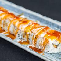 Tiger Roll · Shrimp tempura and snow crab, topped with avocado ebi and sauce.