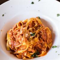 Fettuccine Bolognese · Homemade fettuccine with meat sauce.