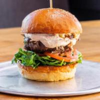 Tavern Burger · Bleu cheese, caramelized onion, bacon aioli, arugula.