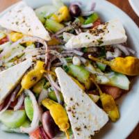 Greek Salad - Large · The traditional village salad, tomatoes, cucumbers, red onions, peppers, Kalamata olives, Fe...