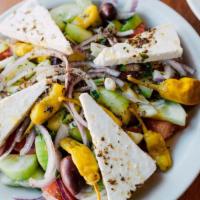 Greek Salad - Small · The traditional village salad, tomatoes, cucumbers, red onions, peppers, Kalamata olives, Fe...