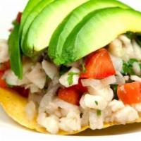 Ceviche De Pescado · A blend of fresh Sea Bass fish, onions, cilantro, tomatoes, cucumber, and avocado cooked in ...