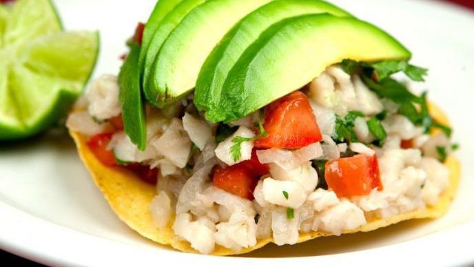 Ceviche De Pescado · A blend of fresh Sea Bass fish, onions, cilantro, tomatoes, cucumber, and avocado cooked in lime juice.