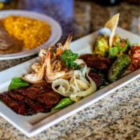 Mar Y Tierra · A 10 oz. skirt steak chargrilled to perfection topped with four jumbo shrimp, grilled onions...